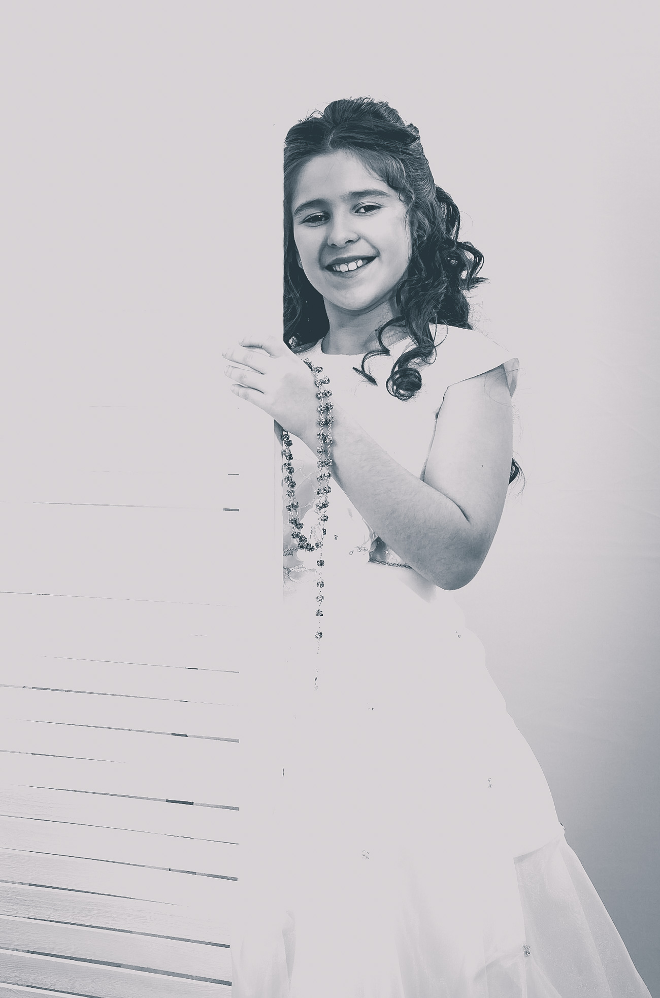 Jeune fille en robe de première communion, sourire radieux
